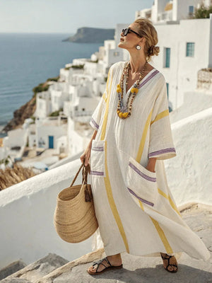 A woman enjoying a coffee outdoors while wearing the Elara loose fit maxi dress, conveying comfort and style.